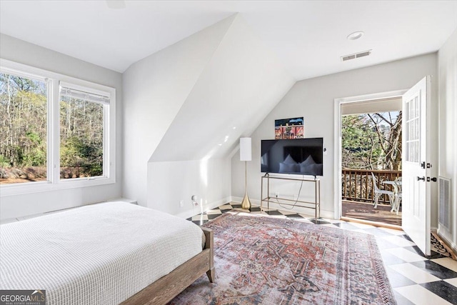 bedroom featuring lofted ceiling, baseboards, visible vents, and tile patterned floors