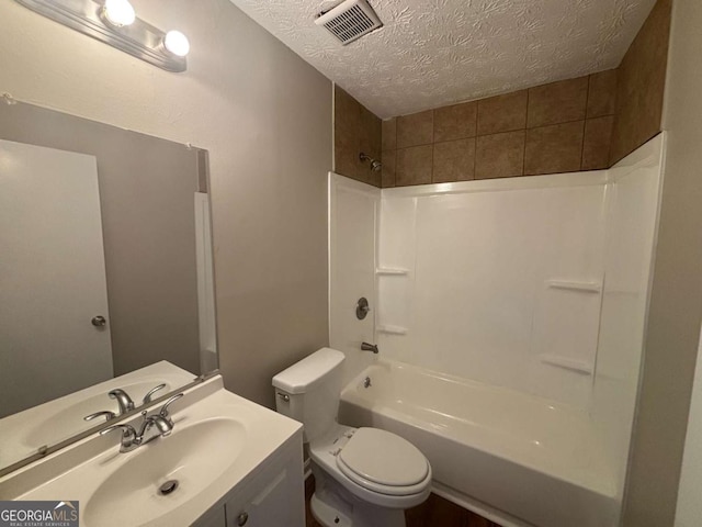 full bath with a textured ceiling, toilet, vanity, visible vents, and shower / washtub combination