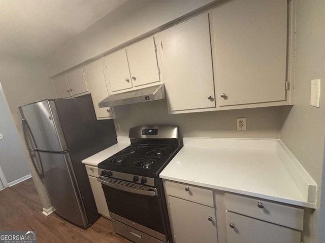 kitchen featuring under cabinet range hood, stainless steel appliances, dark wood-type flooring, and light countertops