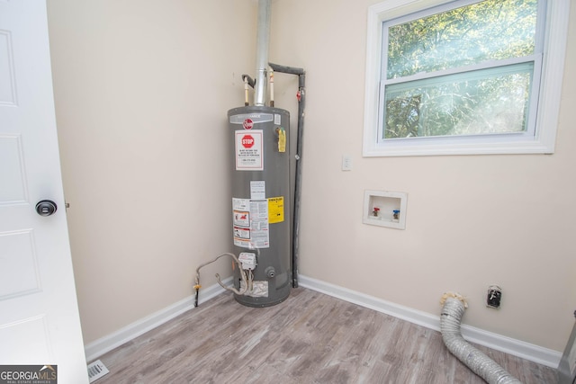 utilities featuring visible vents and gas water heater