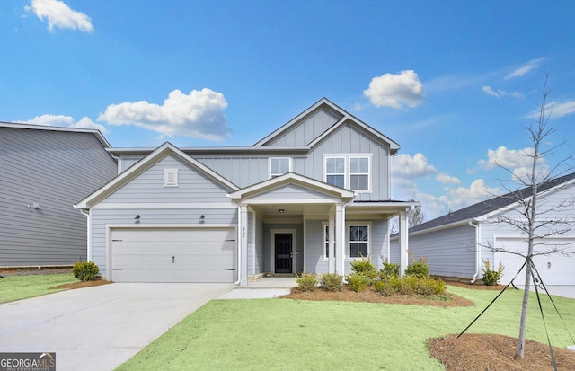 view of front of property with a garage, driveway, a front lawn, and board and batten siding