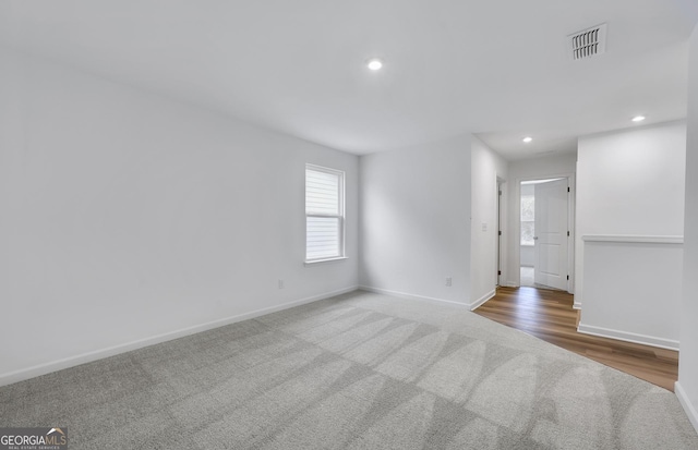 empty room with baseboards, carpet floors, visible vents, and recessed lighting