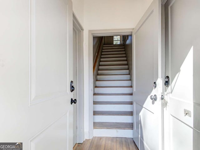 stairway featuring wood finished floors