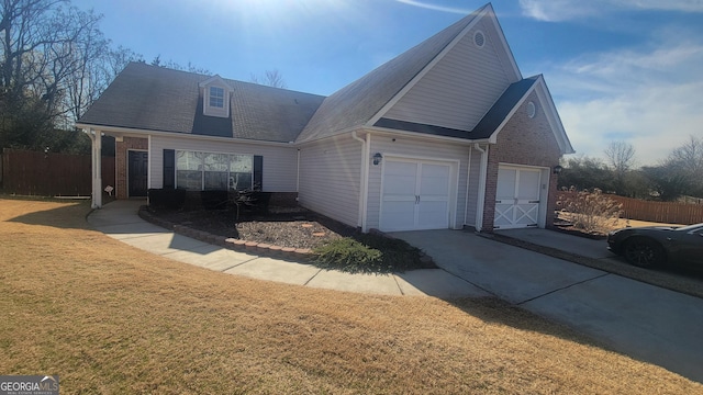 view of front of property featuring a front yard, brick siding, and fence