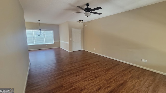 unfurnished room featuring a ceiling fan, dark wood finished floors, and baseboards