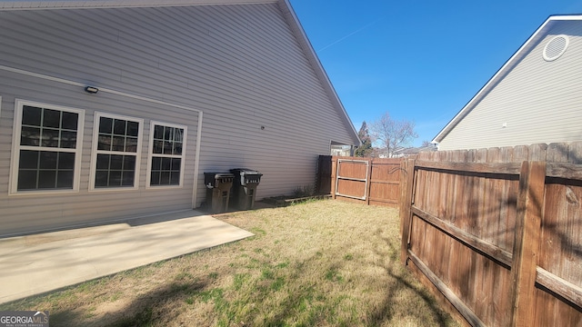 view of yard with fence and a patio