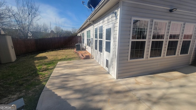 view of home's exterior featuring a yard, cooling unit, a fenced backyard, and a patio