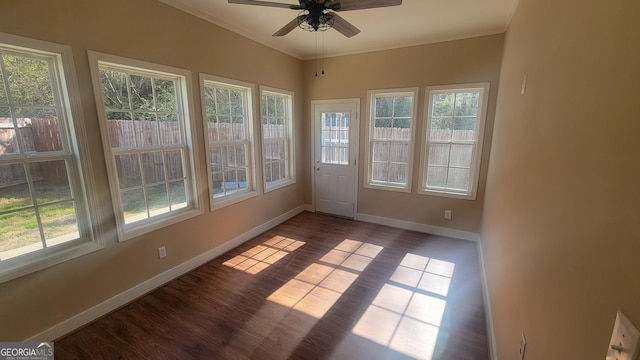 unfurnished sunroom featuring a ceiling fan