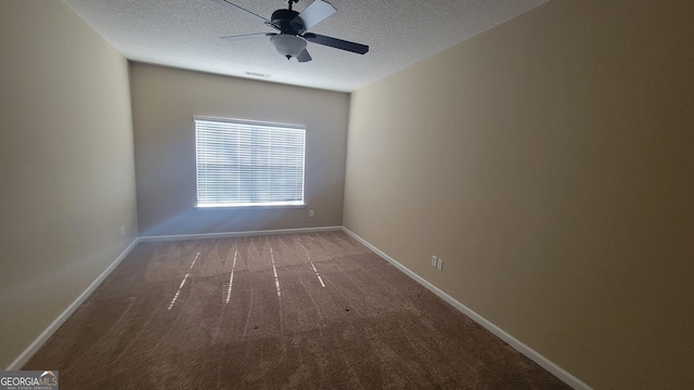 carpeted spare room featuring a ceiling fan, visible vents, baseboards, and a textured ceiling