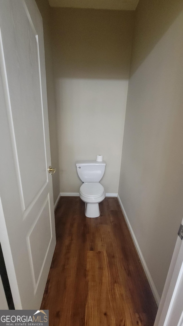 bathroom featuring wood finished floors, toilet, and baseboards