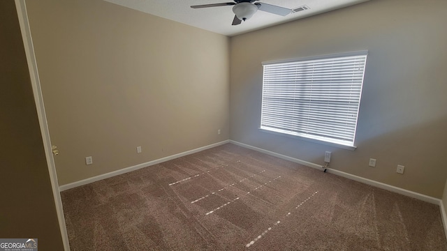 empty room with ceiling fan, carpet flooring, visible vents, and baseboards