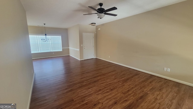 unfurnished room with dark wood-type flooring, ceiling fan, and baseboards