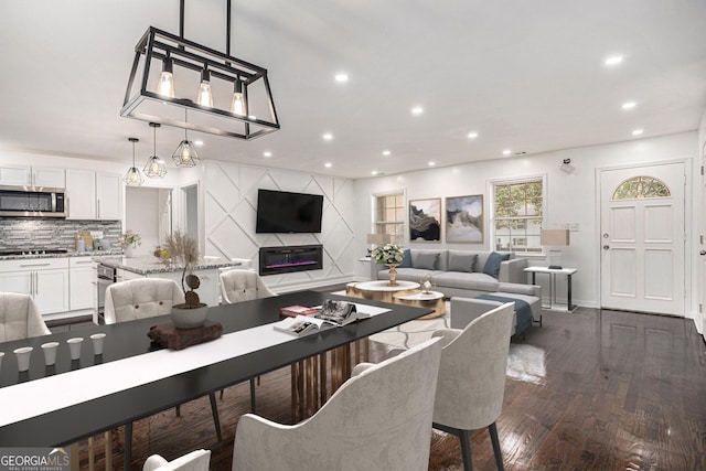 living area with recessed lighting and dark wood-style floors