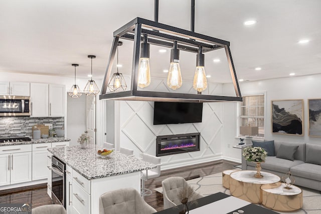 living area featuring dark wood-style floors and recessed lighting