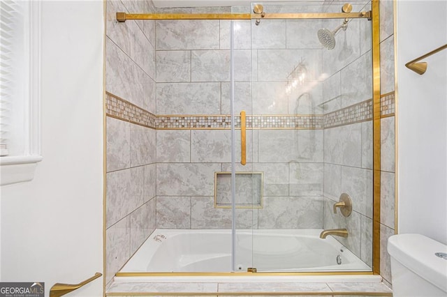 bathroom with shower / bath combination with glass door and toilet