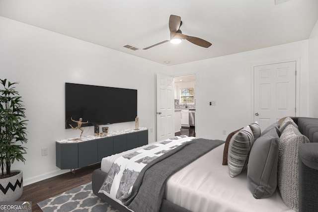 bedroom with baseboards, visible vents, dark wood-style flooring, a sink, and ceiling fan