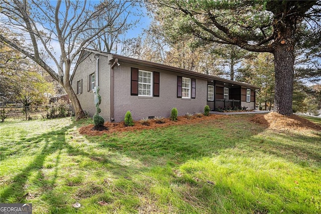 ranch-style home featuring a front lawn, fence, brick siding, and crawl space