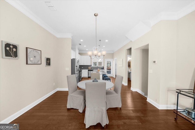 dining area with dark wood finished floors, an inviting chandelier, baseboards, and ornamental molding