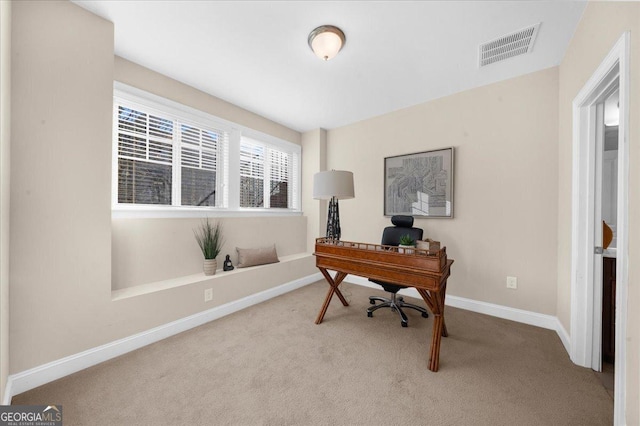 carpeted office with visible vents and baseboards