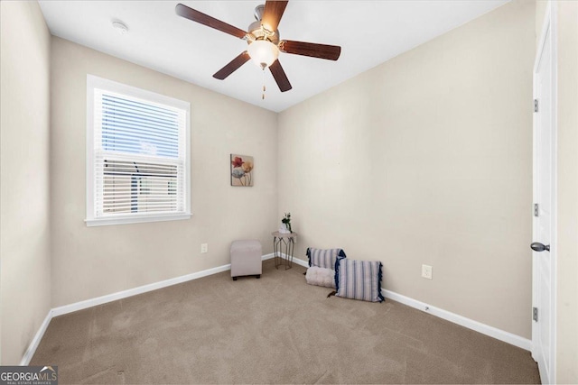 unfurnished room with a ceiling fan, baseboards, and carpet floors