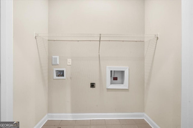 clothes washing area featuring laundry area, hookup for a washing machine, baseboards, and electric dryer hookup