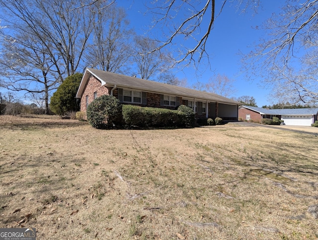 single story home with a garage and brick siding