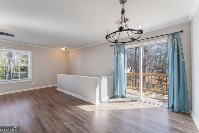 unfurnished dining area featuring visible vents, ornamental molding, wood finished floors, a chandelier, and baseboards