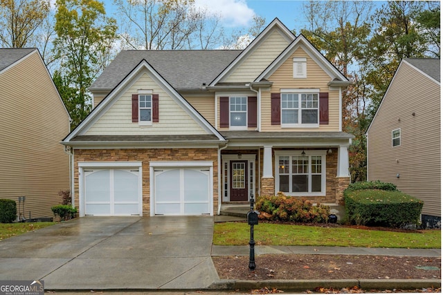 craftsman-style home featuring a garage, stone siding, a shingled roof, and concrete driveway