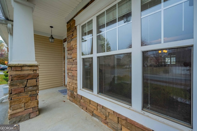 exterior space featuring covered porch and brick siding