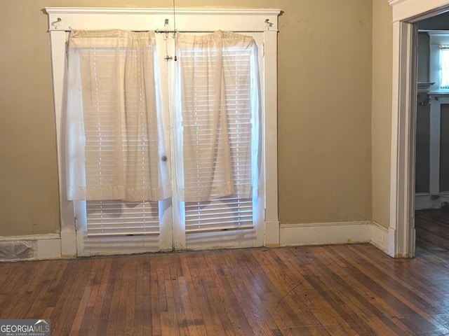 interior space with baseboards and hardwood / wood-style floors