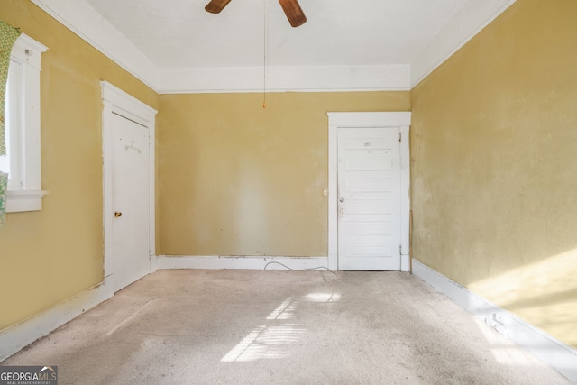 spare room featuring carpet floors and a ceiling fan