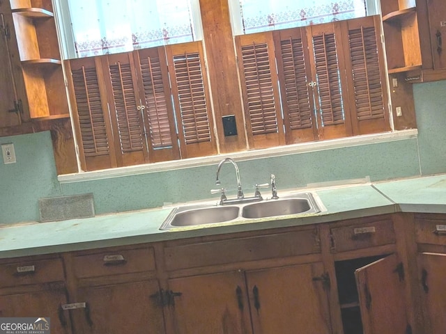 kitchen with open shelves and a sink