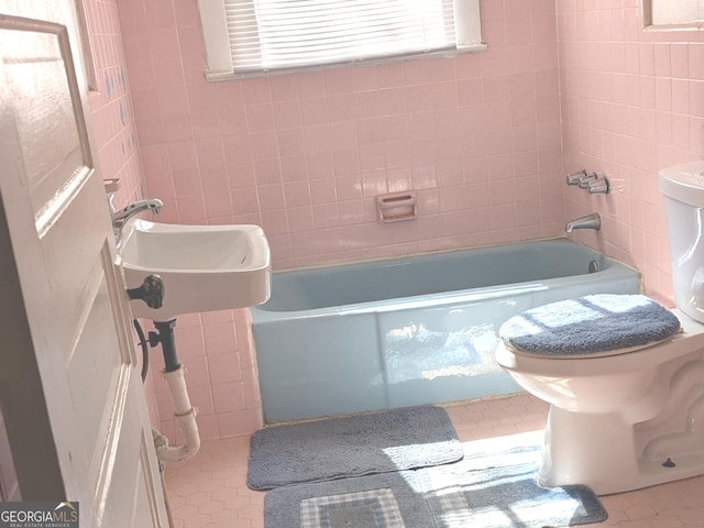 bathroom featuring tub / shower combination, toilet, and tile walls