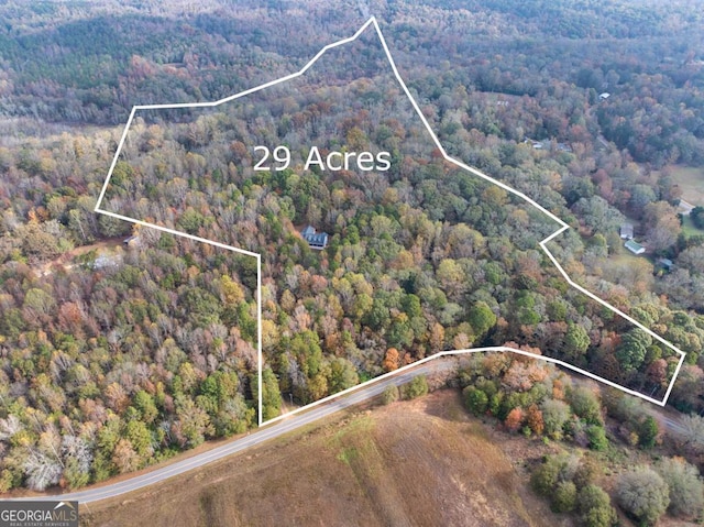 aerial view featuring a wooded view