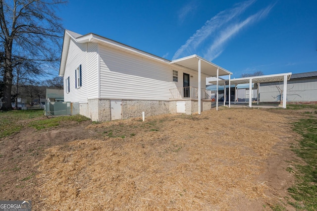 view of side of home featuring a carport and central AC