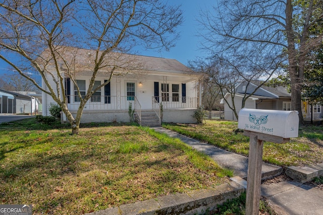 view of front of home with a porch and a front yard