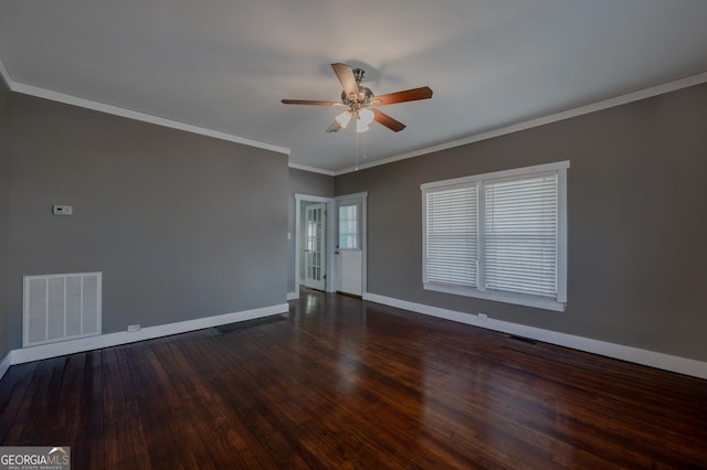 spare room featuring visible vents, crown molding, baseboards, and hardwood / wood-style flooring