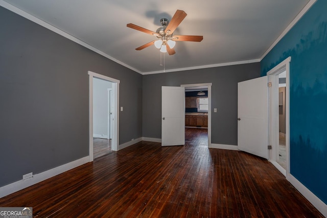 unfurnished bedroom with crown molding, baseboards, and hardwood / wood-style flooring