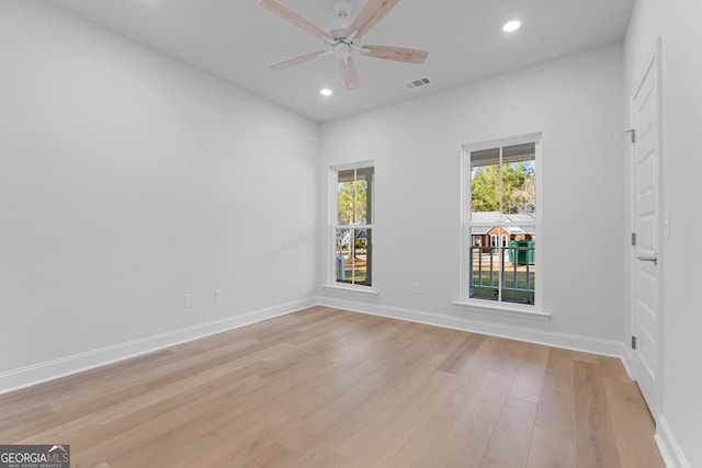 empty room with light wood finished floors, recessed lighting, visible vents, and baseboards