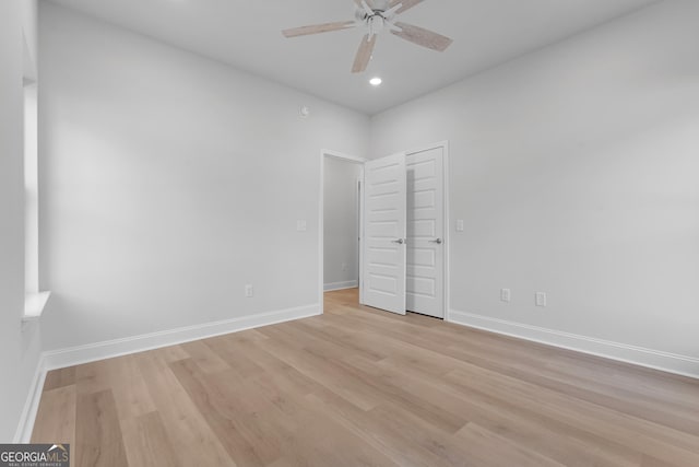 unfurnished bedroom featuring light wood-type flooring, baseboards, and recessed lighting