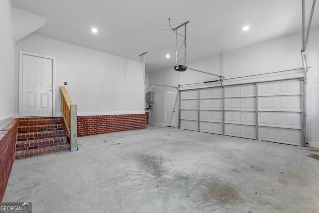 garage featuring a garage door opener and recessed lighting