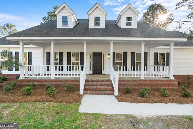 view of front of house with covered porch and roof with shingles