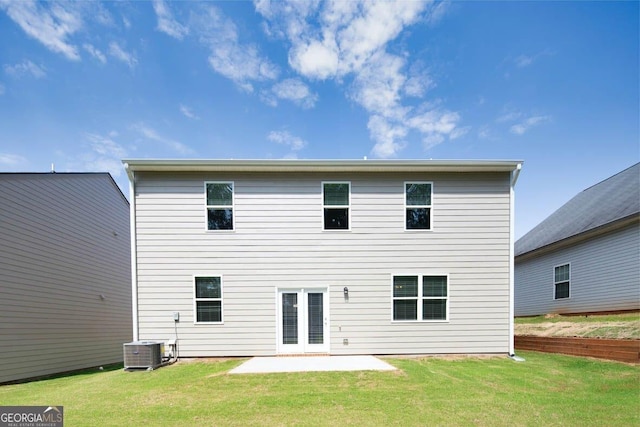 back of house featuring a patio area, a lawn, and central air condition unit