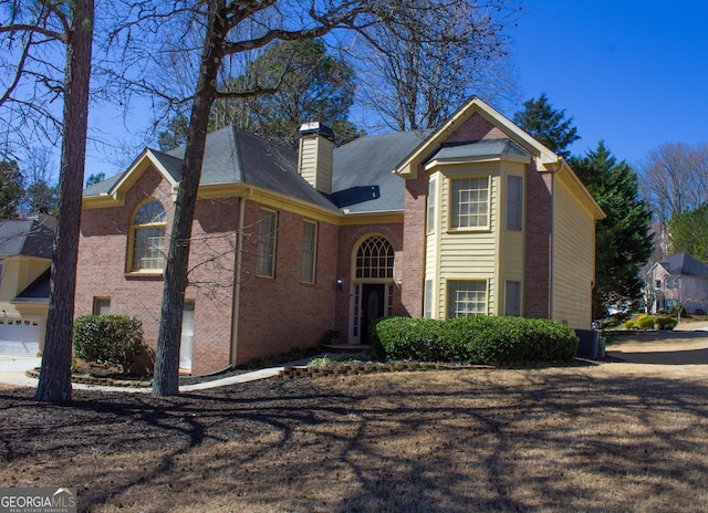 traditional home with a chimney and brick siding