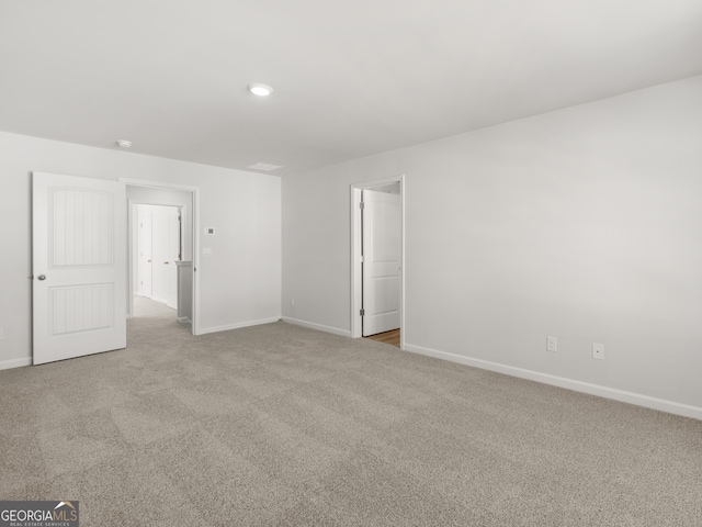 unfurnished bedroom featuring carpet flooring and baseboards