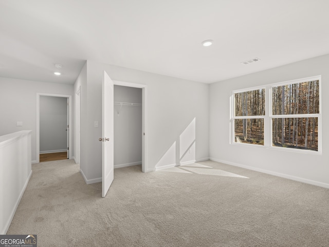 interior space with baseboards, visible vents, carpet floors, a closet, and recessed lighting