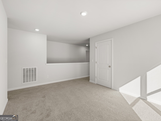 empty room featuring carpet floors, recessed lighting, visible vents, and baseboards