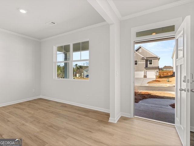 interior space featuring baseboards, wood finished floors, and crown molding