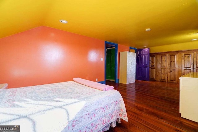 bedroom featuring vaulted ceiling and wood finished floors