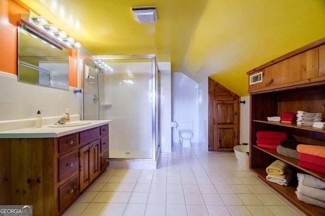 bathroom with lofted ceiling, a shower stall, visible vents, and tile patterned floors